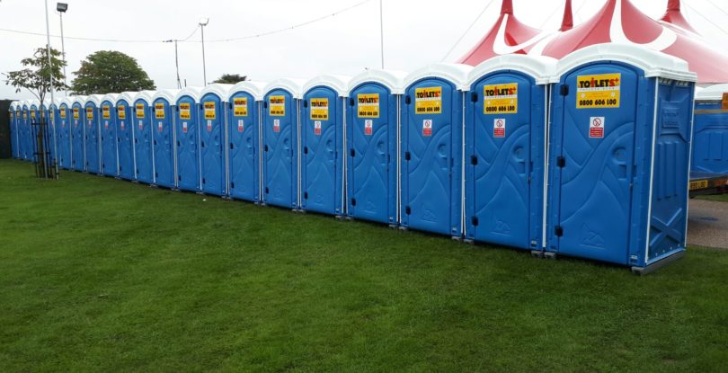 Standard toilets lined up at event