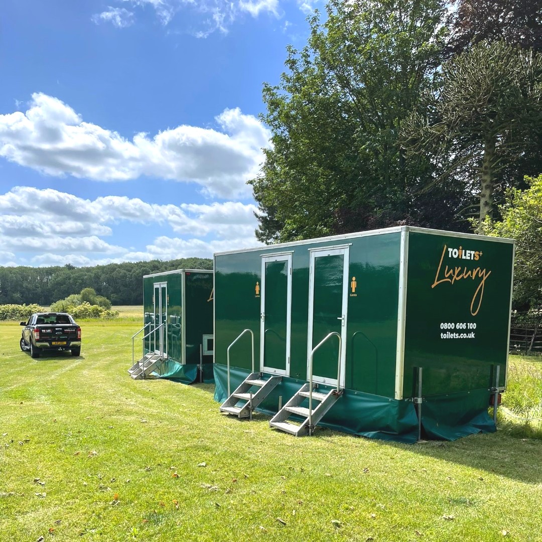 two luxury toilet trailers for hire in a field