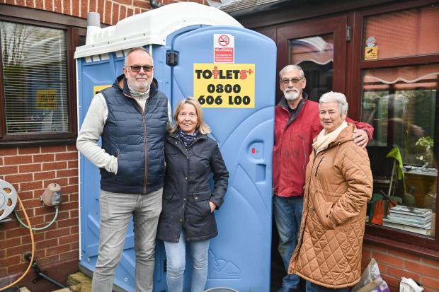 hickling residents standing in front of toilets+ portable toilet